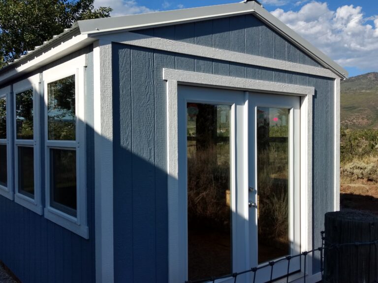 Ranch Style wood shed with french doors, windows, and painted