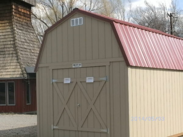 Loft Style wood shed with double doors and a red metal roof